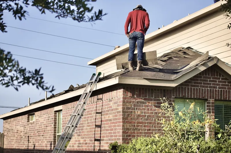 Professional roofer working on a residential roof in Villages of Woodland Springs